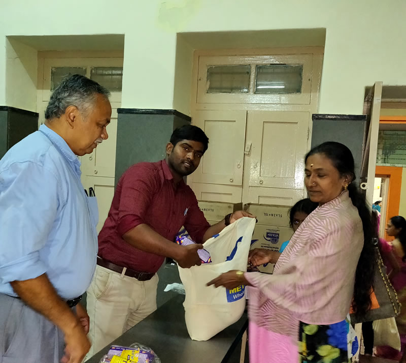 BKF staff handing a support kit to a patient at a Bangalore Kidney Foundation centre